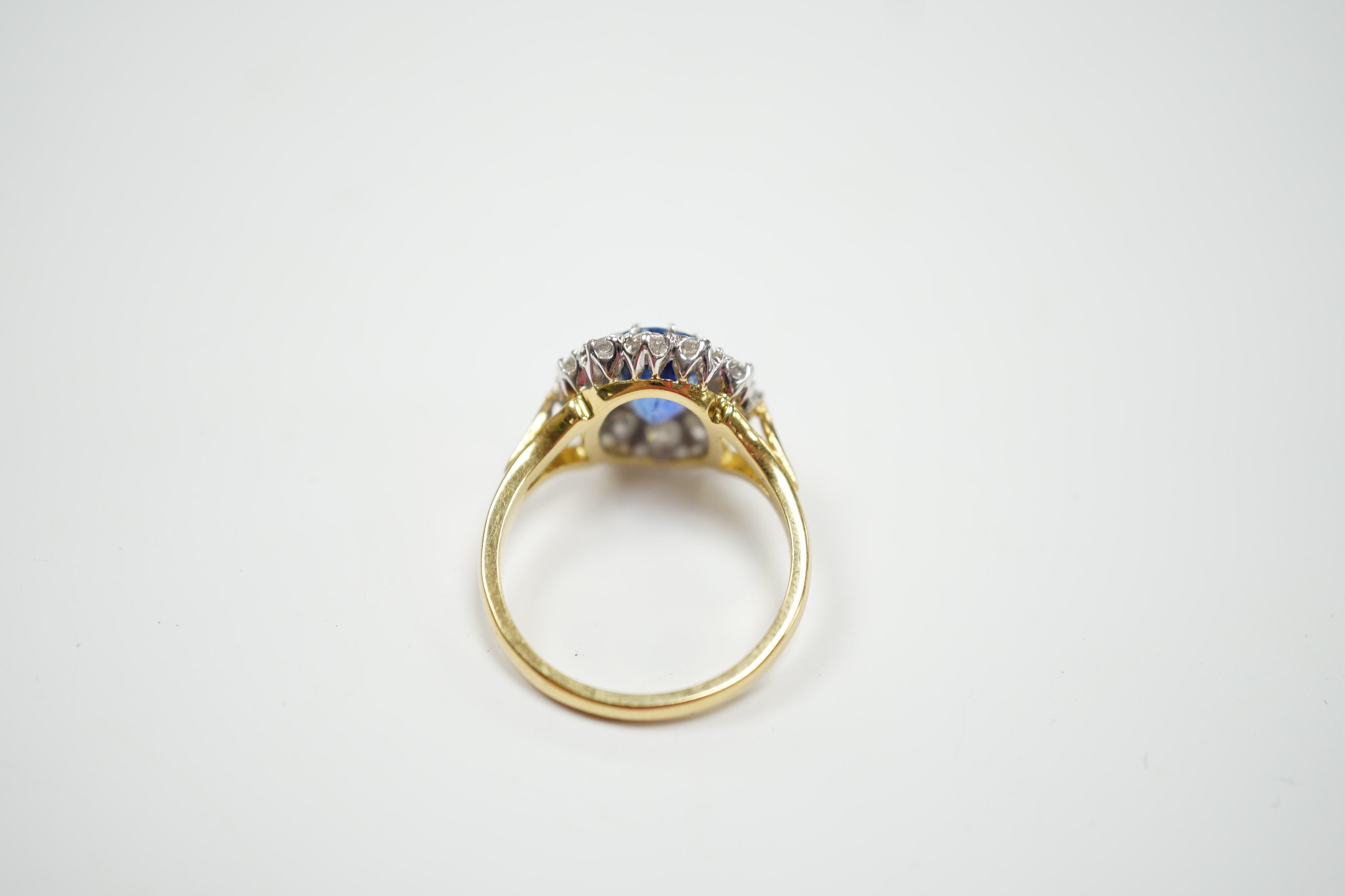 A modern 18ct gold, sapphire and diamond set oval cluster ring, size O, gross weight 5.6 grams.